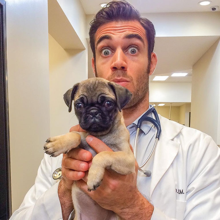 Sexy vet posing with one of his patients 