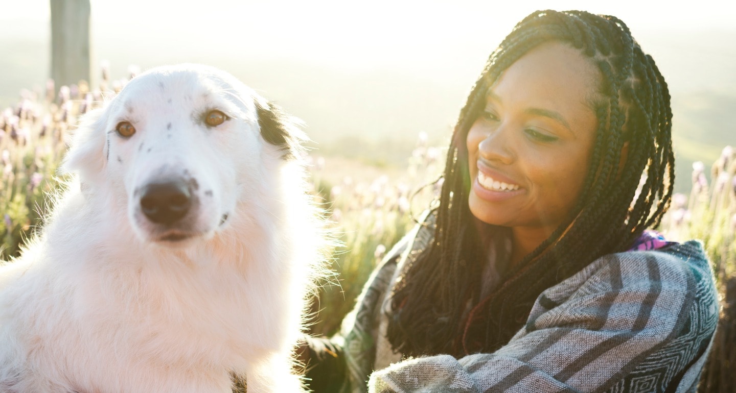 https://media-be.chewy.com/wp-content/uploads/2020/02/27122508/woman-and-a-beautiful-dog-sitting-on-the-floor-in-a-flower-field-picture-id1161599203.jpg