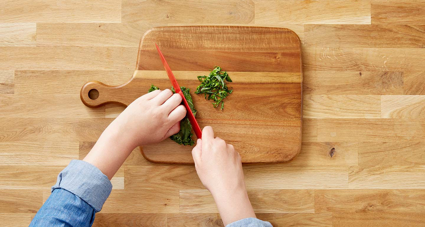 Cut the kale leaf into ribbons and top each mold with the garnish.