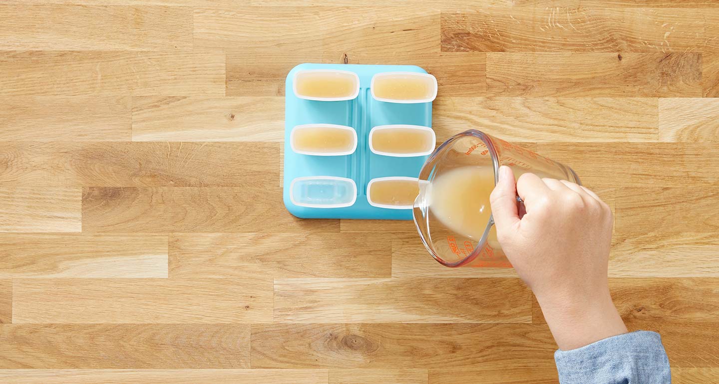 Fill each popsicle mold halfway with bone broth.