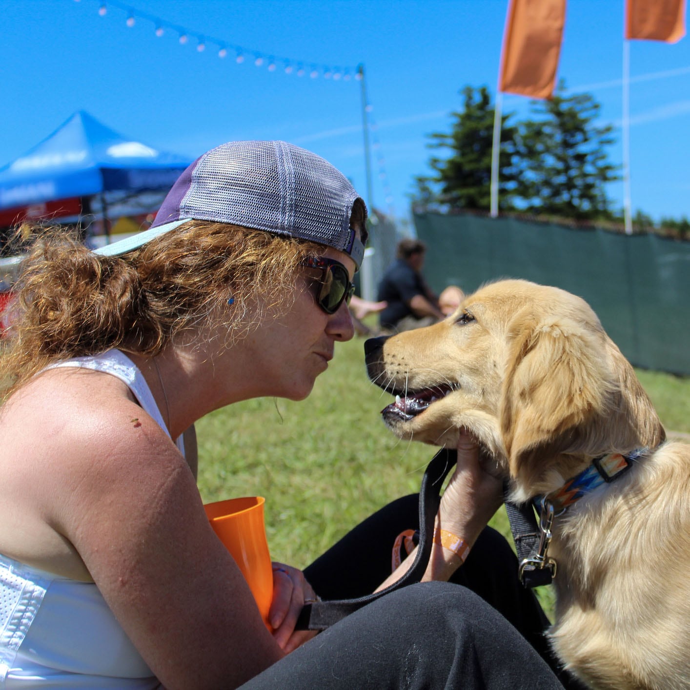 dog with woman at festival