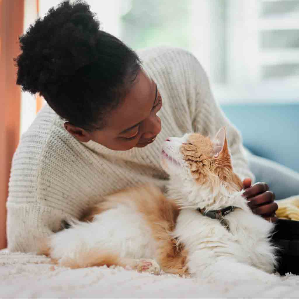 woman and cat snuggling