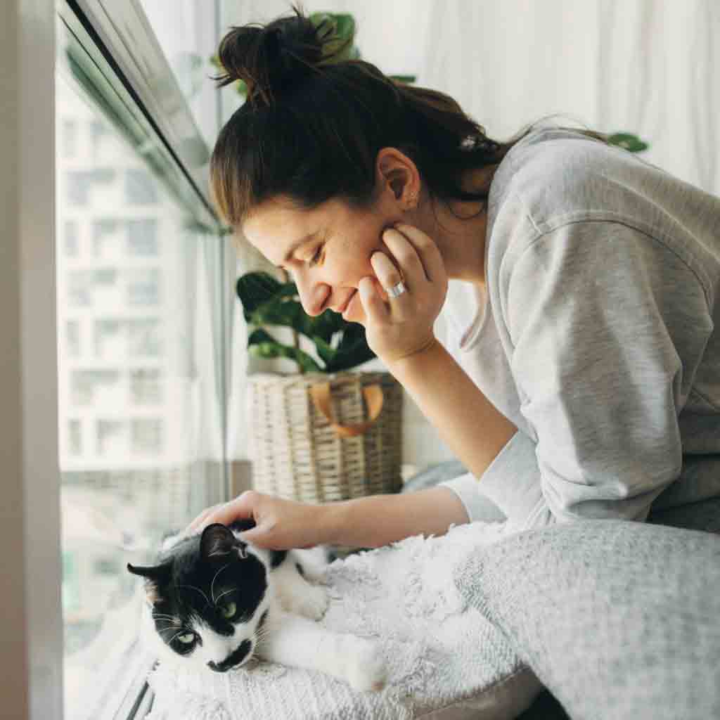 woman in pajamas with cat