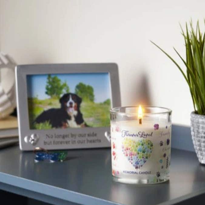 a memorial pet candle burning on a tabletop