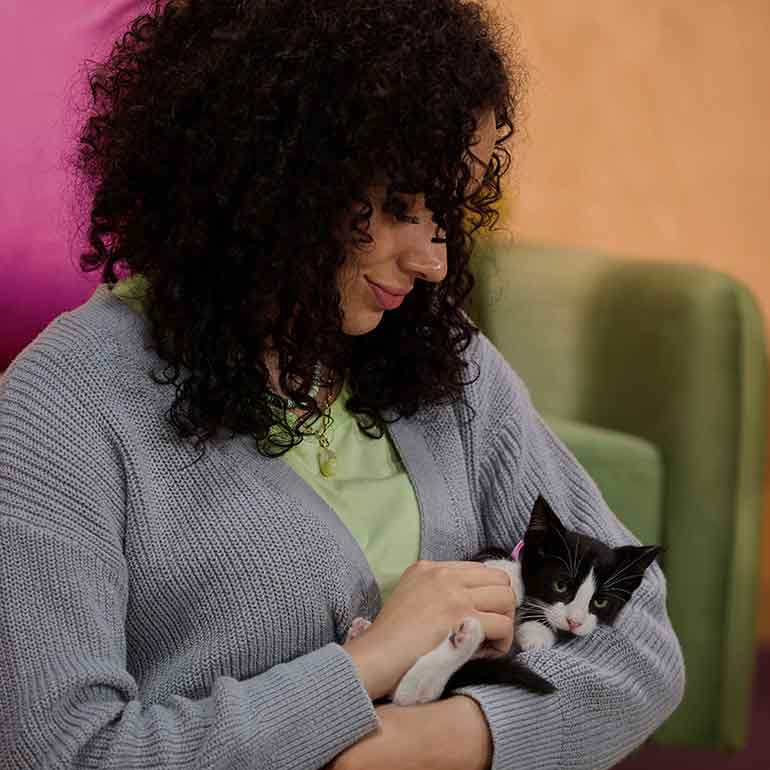 A woman holding a kitten