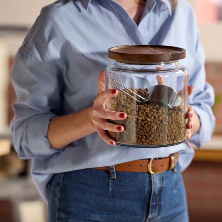 Photo of a woman holding a jar of cat food